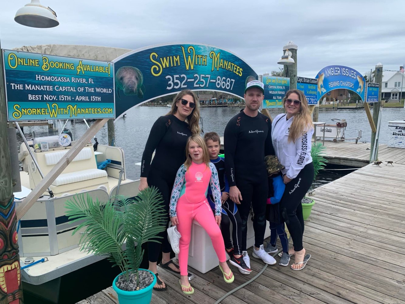 a group of people standing next to a sign