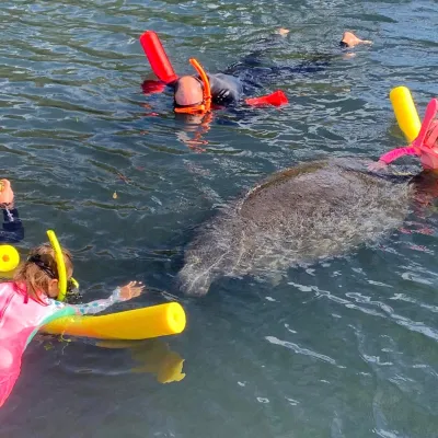 a group of people on a raft in a body of water
