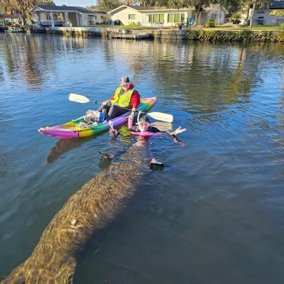 a man standing next to a river