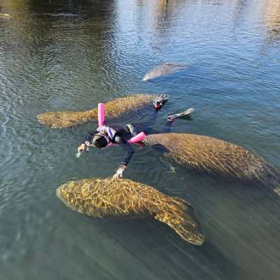 a man sitting next to a body of water