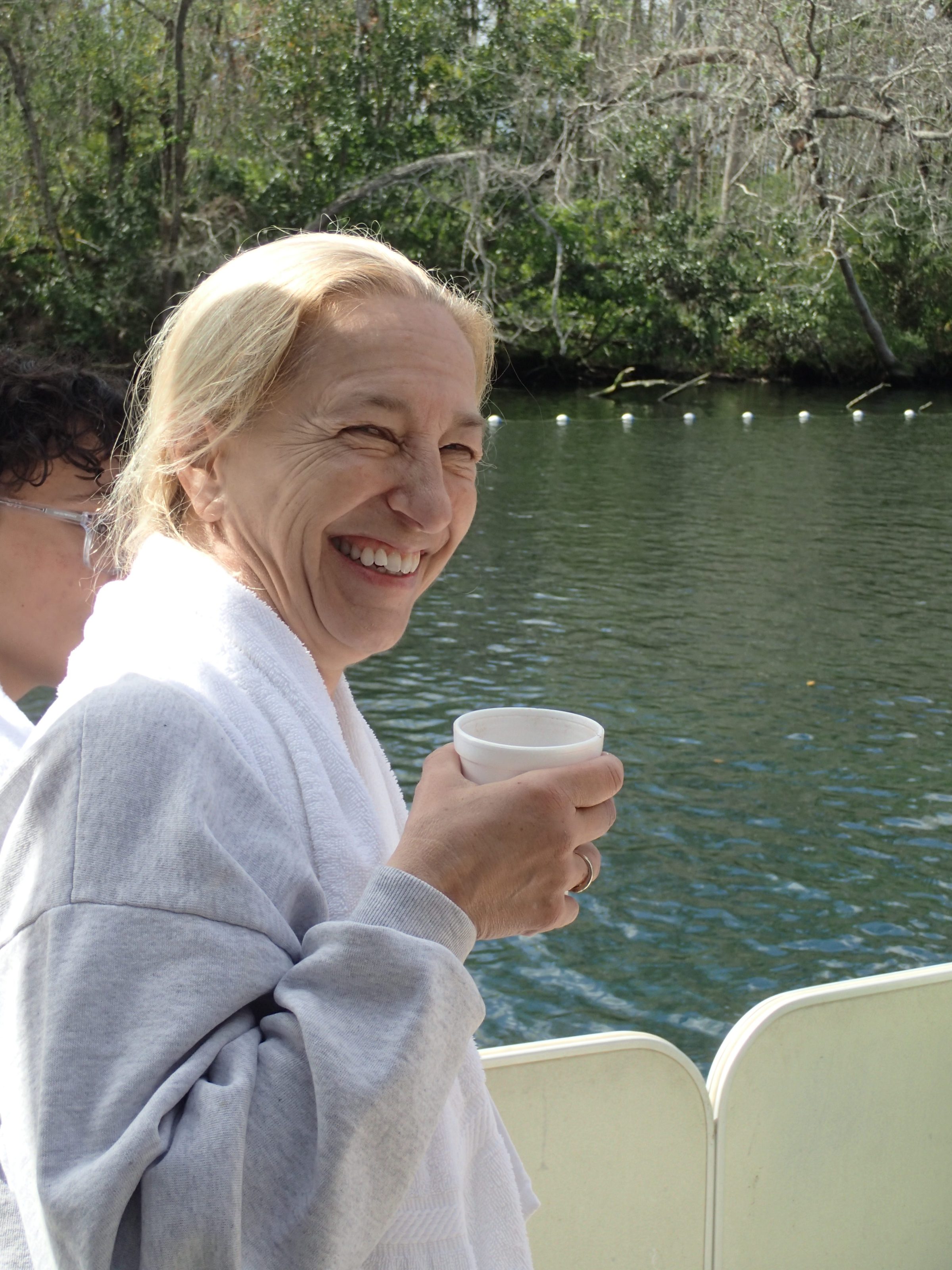 a person sitting next to a lake